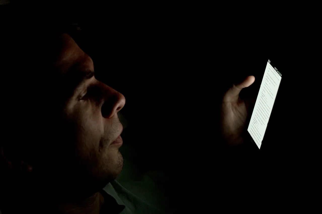 Person looking at smartphone in the dark (2)